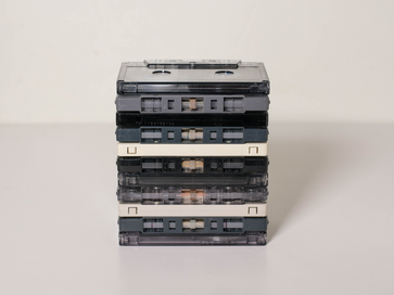11 audio tapes stacked neatly ontop of each other