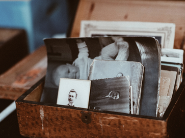 box of old, worn looking photographs